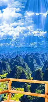 Breathtaking mountainous landscape under a vibrant blue sky, viewed from a wooden deck.