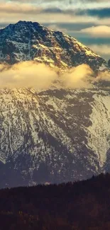 Snow-capped mountain with golden light through clouds.