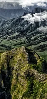 Stunning green mountain landscape with towering peaks and lush valleys.