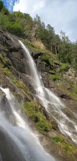 Majestic waterfall cascading down a rocky mountainside with lush greenery.