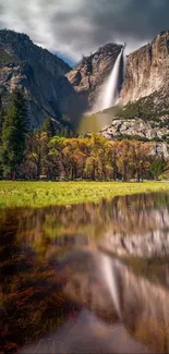 Mountain waterfall reflecting in a serene lake.