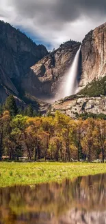 Scenic mountain view with cascading waterfall and autumn foliage.