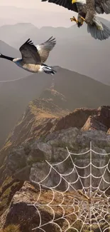 A majestic scene with birds and spiderweb over mountainous landscape.