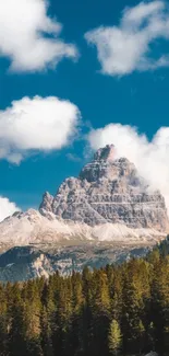 Mountain peak surrounded by clouds and blue sky.