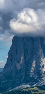 Majestic mountain peak with cloud cap on a serene day.