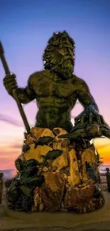 Neptune statue silhouetted against a vibrant sunset.