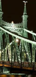 A beautifully illuminated European bridge at night.