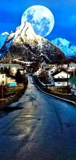 Moonlit mountain village under a blue night sky wallpaper.