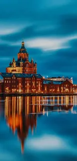 Majestic cityscape at night with glowing reflections on water.