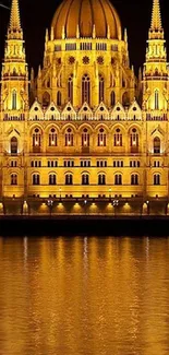 Illuminated building with golden reflections on water at night.