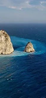 Breathtaking view of rocky cliffs by the ocean under a clear blue sky.