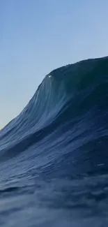 Majestic ocean wave cresting under a clear blue sky.