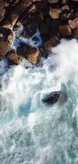 Aerial view of powerful ocean waves crashing against rocky shore.