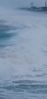 Powerful ocean waves crash on a serene beach.