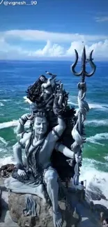 Shiva statue with ocean backdrop and blue sky.