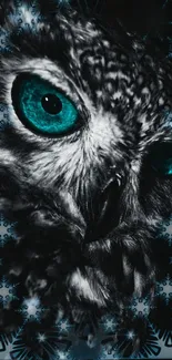 Close-up of owl with teal eyes and detailed feathers on a dark background.