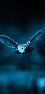 Majestic owl soaring in deep blue hue.