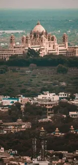 Aerial view of a majestic palace surrounded by city and greenery.