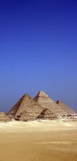 Mobile wallpaper of Egyptian pyramids under a vibrant blue sky.