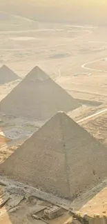 Golden pyramids in Egyptian desert at sunset.