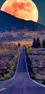 Moonlit road leading to mountains under a vibrant full moon.