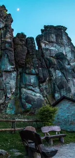 Majestic rock formations under a blue sky with benches in the foreground.