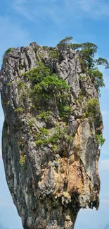 Rock formation against blue sky wallpaper.