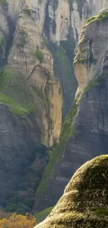 Wallpaper of majestic rock formations with greenery.