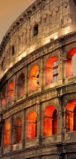 Roman Colosseum glowing in orange tones at night.