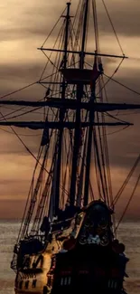 A classic ship sails into the warm brown sunset on a calm ocean.