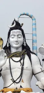 Majestic white Shiva statue with trident and serene expression.