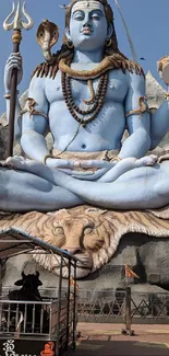 Shiva statue with blue tones and detailed features for mobile wallpaper.