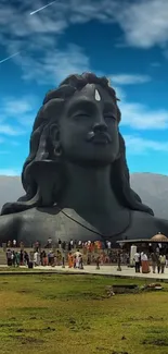 Majestic Shiva statue with blue sky and green landscape in stunning HD.