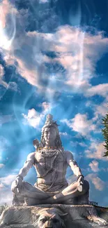 Majestic Shiva statue under vibrant blue sky with clouds.