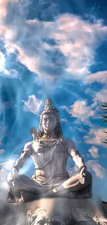 Majestic statue of Shiva under a blue sky with clouds.