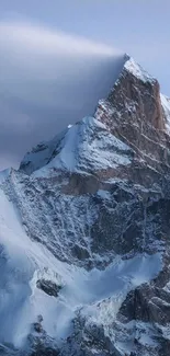 Snow-capped mountain peak under a serene blue sky.