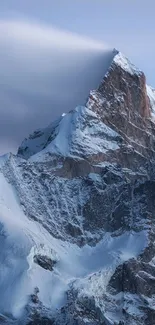 Snow-capped mountain peak under a blue sky.