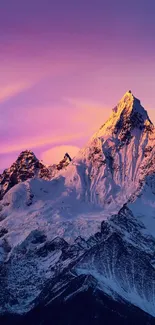 Snowy mountain at sunset with purple sky.