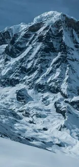 Snow-covered mountain peak under a clear blue sky.