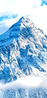 Snowy mountain peak under a vivid blue sky with clouds.