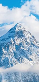 Snowy mountain peak with blue sky backdrop.