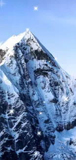 Snow-covered mountain peak with blue sky backdrop.