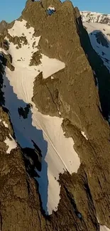 Snowy mountain peaks under blue sky.