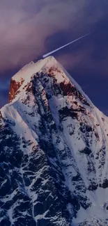 Snow-capped mountain peak under vibrant sky.