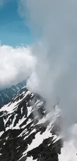 Snowy mountain peaks with blue sky and clouds.