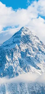 Snow-covered mountain with blue sky and clouds