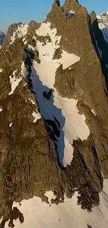 Snowy, rugged mountain peaks under a clear blue sky.