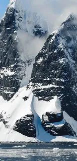 Majestic snowy mountains with rugged peaks and clouds.