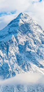 Snow-covered mountain with blue sky background.