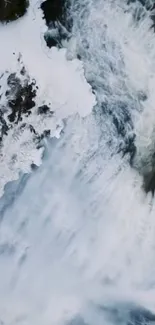 Snowy waterfall surrounded by winter landscape.